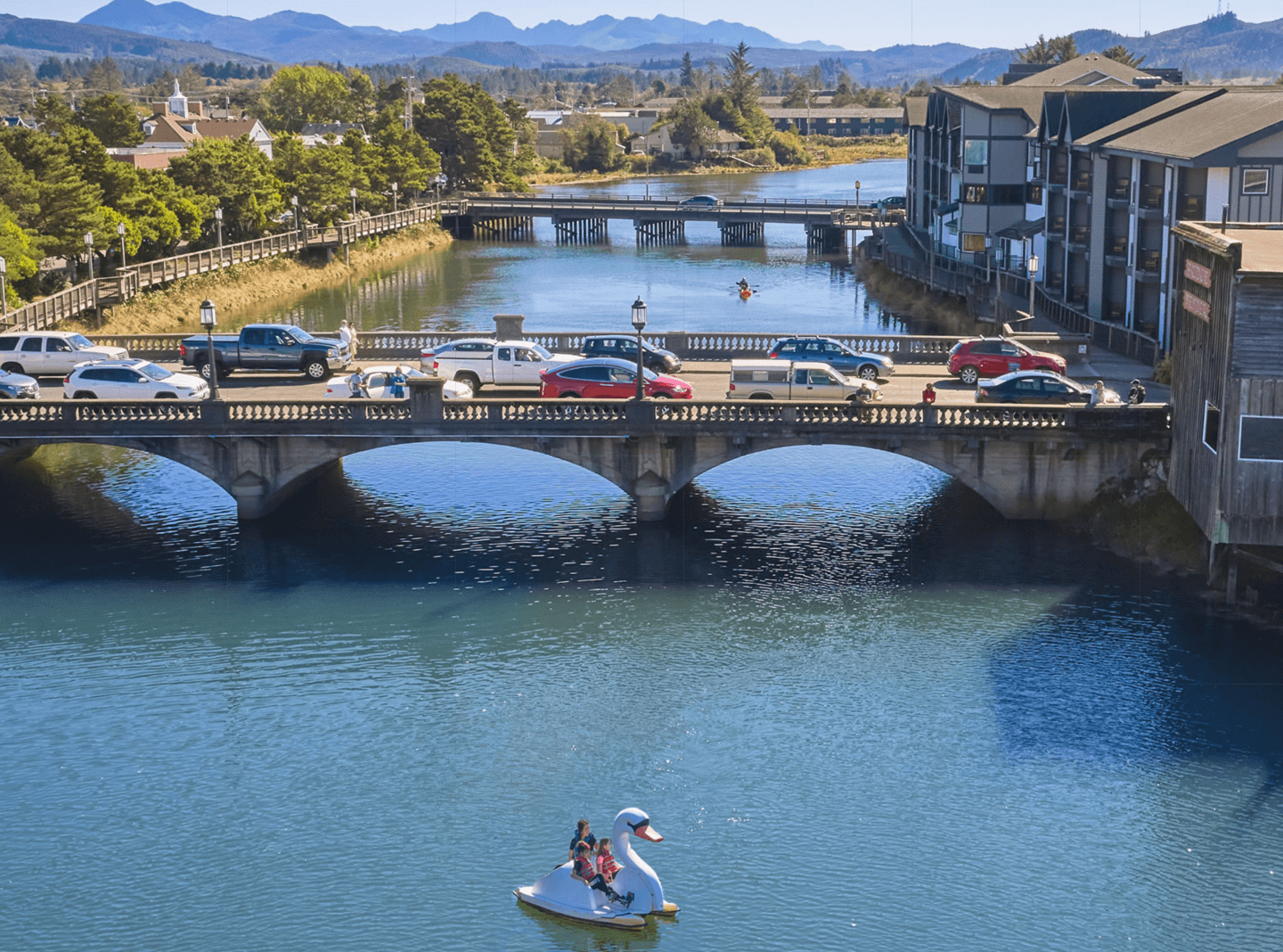 Image of a bridge over a river with cars on it